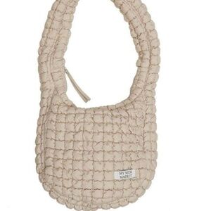 My Mum Made It Puffy Puffer Bag in off-white or beige.